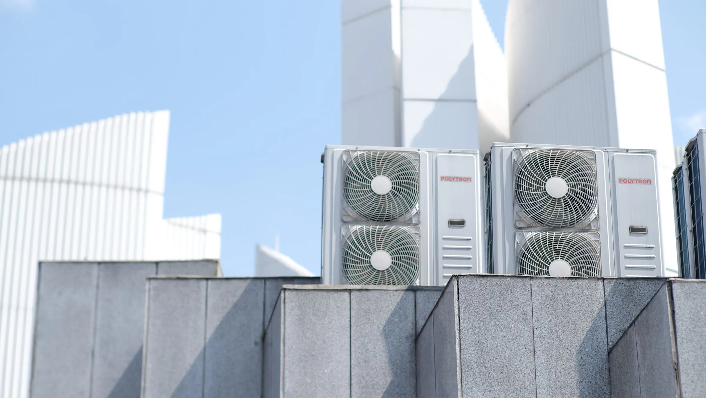 Industrial HVAC cooling units and fans on data center rooftop generating acoustic noise