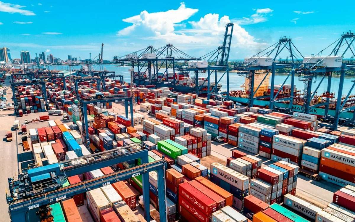 Shipping containers stacked at a port terminal awaiting customs clearance