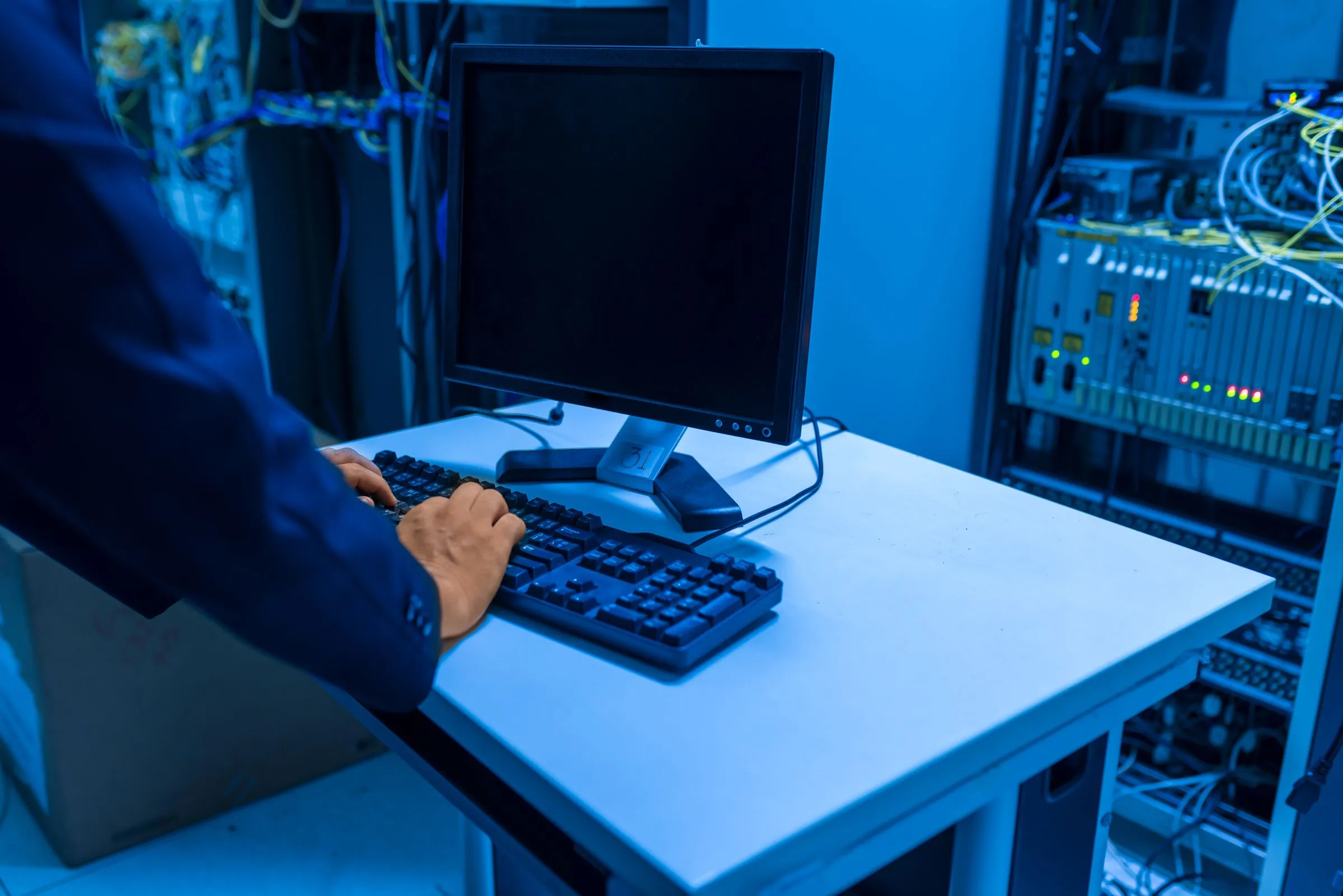 Data center network operations center with monitoring displays and server infrastructure