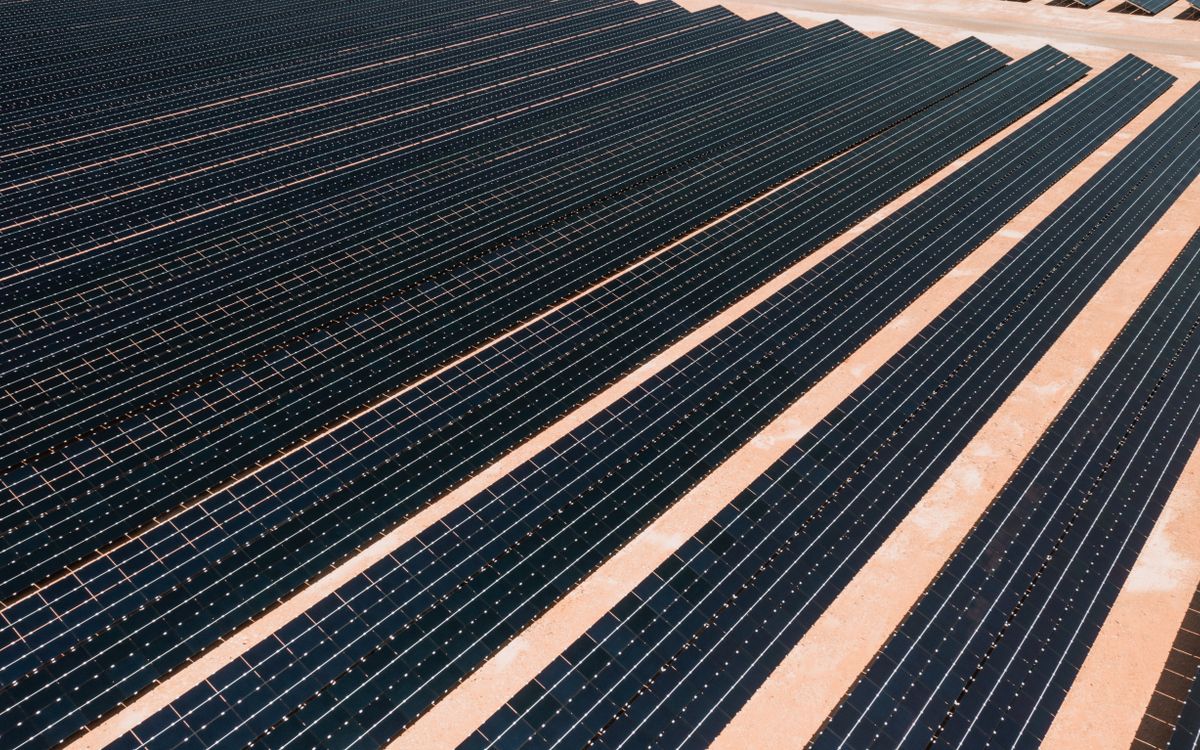 Aerial view of a large-scale solar farm powering data center renewable energy procurement in the UAE