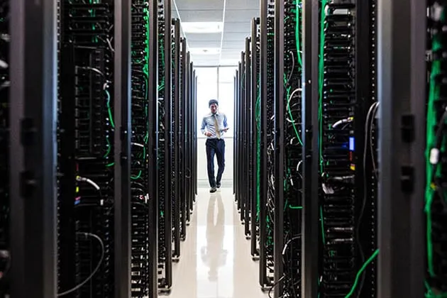 Enterprise data center infrastructure with server racks and power distribution units in a climate-controlled facility