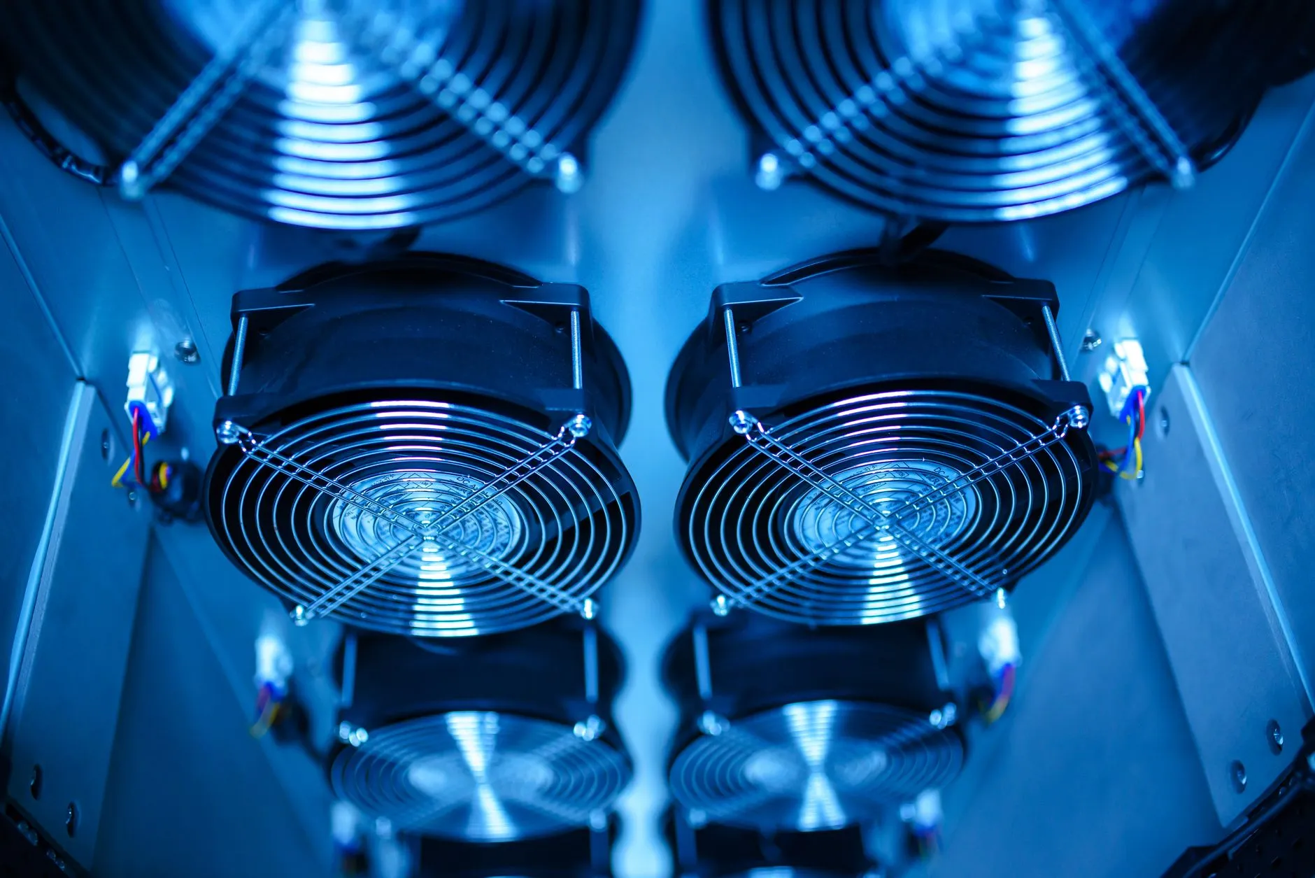 Close-up of liquid cooling pipes and manifolds inside a modern data center server room